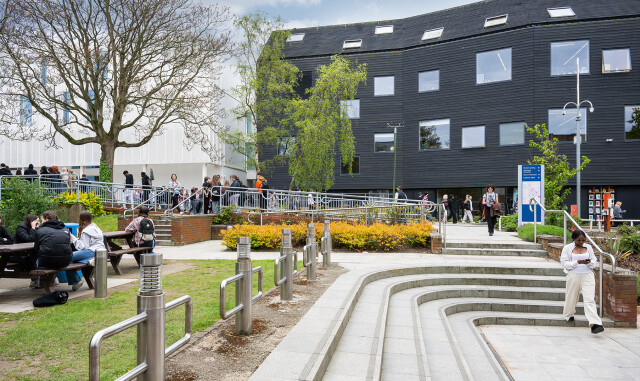City College Norwich campus. Bustling with students outside, and with a view of the Creative Arts building.