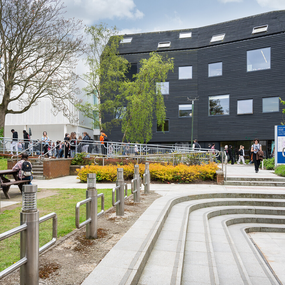 City College Norwich campus. Bustling with students outside, and with a view of the Creative Arts building.